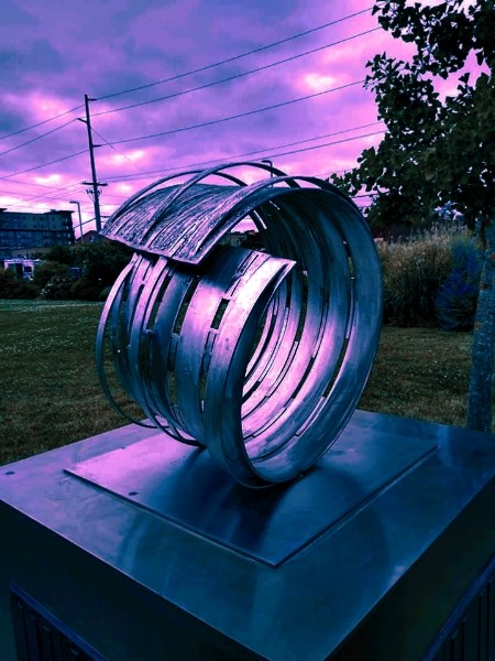 A metal sculpture forming a broken circle